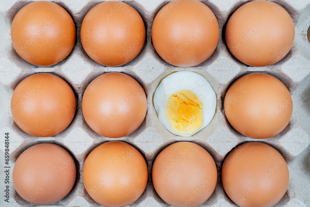 Chicken egg is half broken among other eggs Chicken egg is half broken among other eggs
