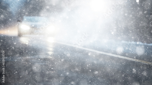 snowfall, car, background in a snowstorm with a copy of the space, the headlights of an oncoming car through a thick snowfall, winter view on the highway, headlight light