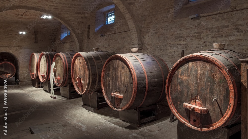 Wine barrels in a historic cellar in central Italy Wine barrels in a historic cellar in central Italy