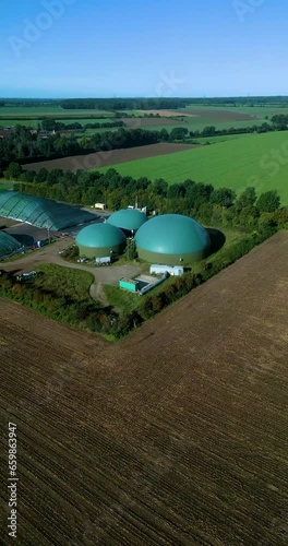 drone flight over a biogas building on a field in 60fps