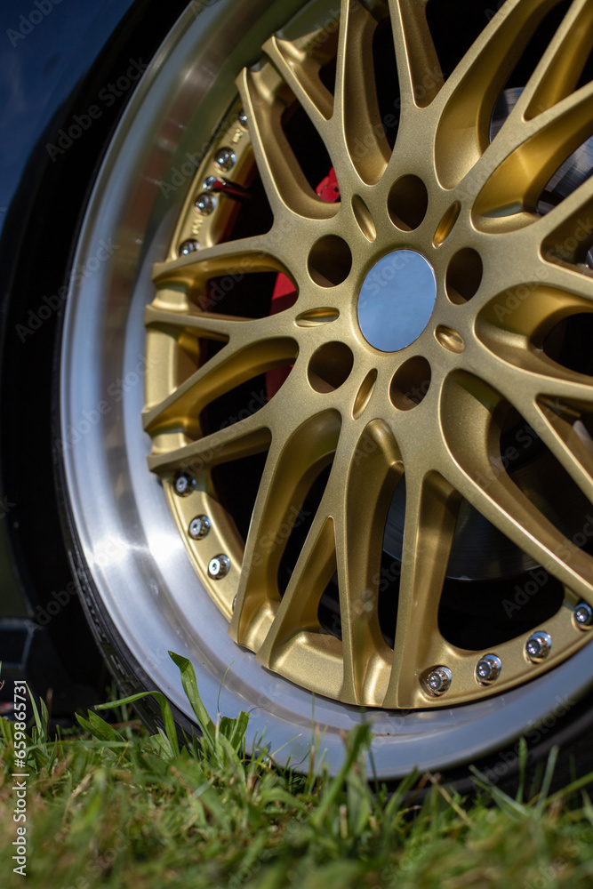 Details of exclusive alloy wheel on a sports car, tuning show