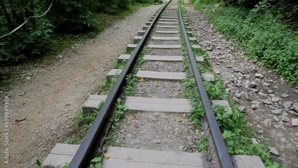 An old narrow gauge railway in a beautiful gorge in the mountains. The railway passes through the mountains and the forest. Slow movement along the rails. An old narrow gauge railway in a beautiful gorge in the mountains. The railway passes through the mountains and the forest. Slow movement along the rails.