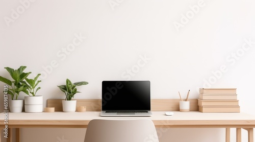 A minimalist office desk bathed in gentle natural light, featuring a laptop. © sopiangraphics