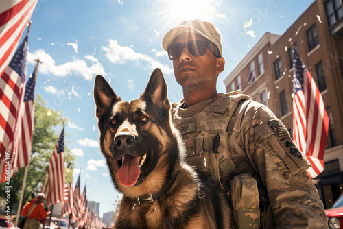 A male soldier in a military uniform stands with a guard, a working dog outdoors on a sunny day, with American flags in the background on the city street, decorated in honor of Remembrance Day photo