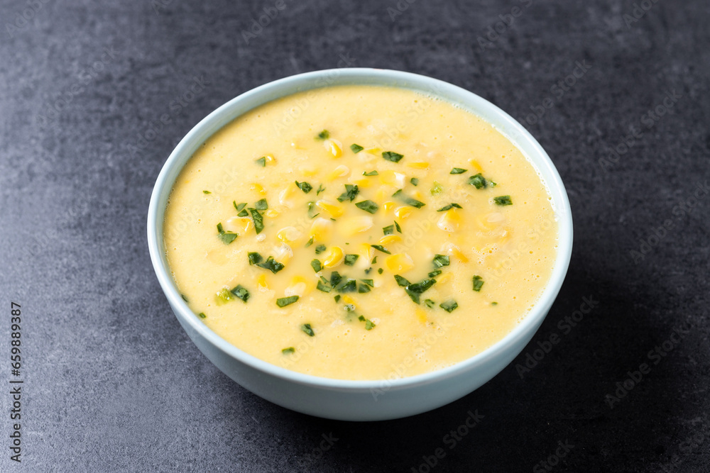 Corn soup in green bowl on black background Corn soup in green bowl on black background