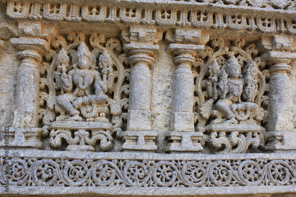 Close up of detailed stone carving of deities, goddess on the shrine wall at Chennakesava Temple, Hoysala Architecture, Somanthpur, Karnataka, India.