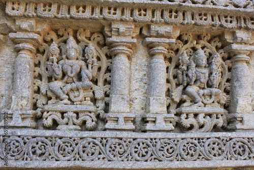 Close up of detailed stone carving of deities, goddess on the shrine wall at Chennakesava Temple, Hoysala Architecture, Somanthpur, Karnataka, India.