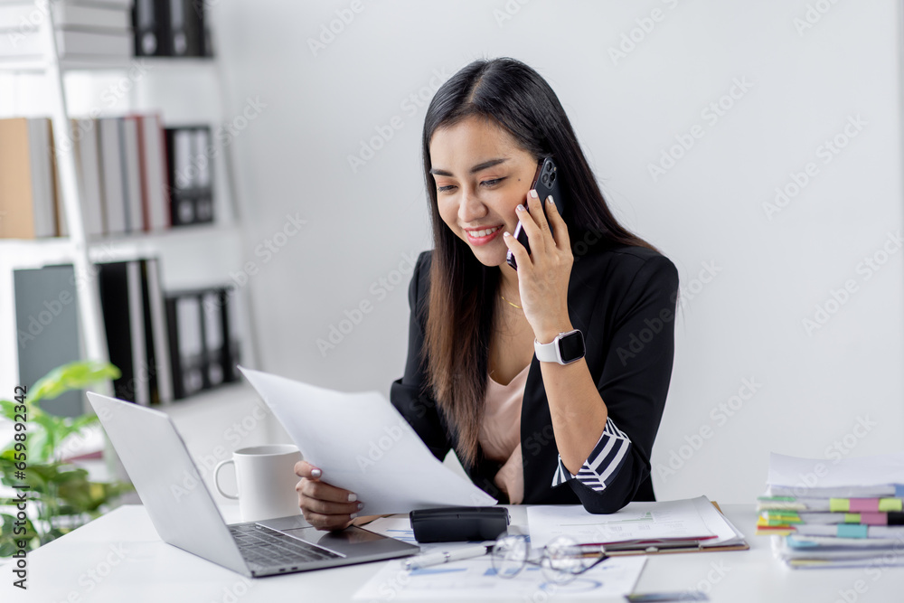 Cheerful business Asian woman office making telephone call share good news about project working in office workplace, business finance documents concept. Cheerful business Asian woman office making telephone call share good news about project working in office workplace, business finance documents concept.