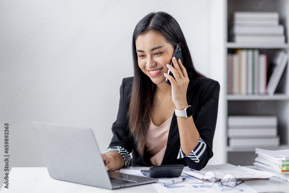 Cheerful business Asian woman office making telephone call share good news about project working in office workplace, business finance documents concept. Cheerful business Asian woman office making telephone call share good news about project working in office workplace, business finance documents concept.