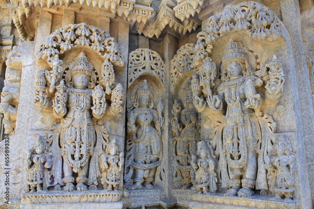 Close up of detailed stone sculpture of deities on the shrine wall and pillars at Chennakesava Temple, Hoysala Architecture , Somanathpur, Karnataka, India