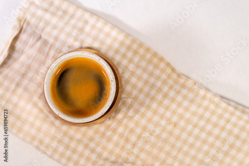 Piccolo coffee photographed from above with a checkered cloth base.