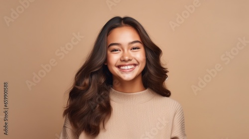 Against a clean and luminous studio background, a teen girl grins with confidence, creating a captivating portrait. © iuricazac