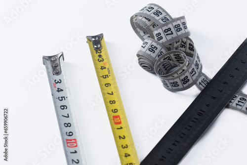 measuring length, meter, tape measure ruler on white background. photo