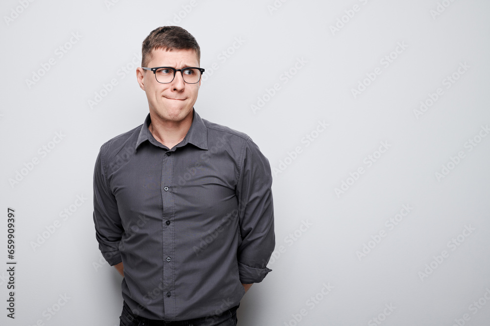 Portrait of clever man in shirt thinks doubts chooses isolated on white studio background with copy space Portrait of clever man in shirt thinks doubts chooses isolated on white studio background with copy space