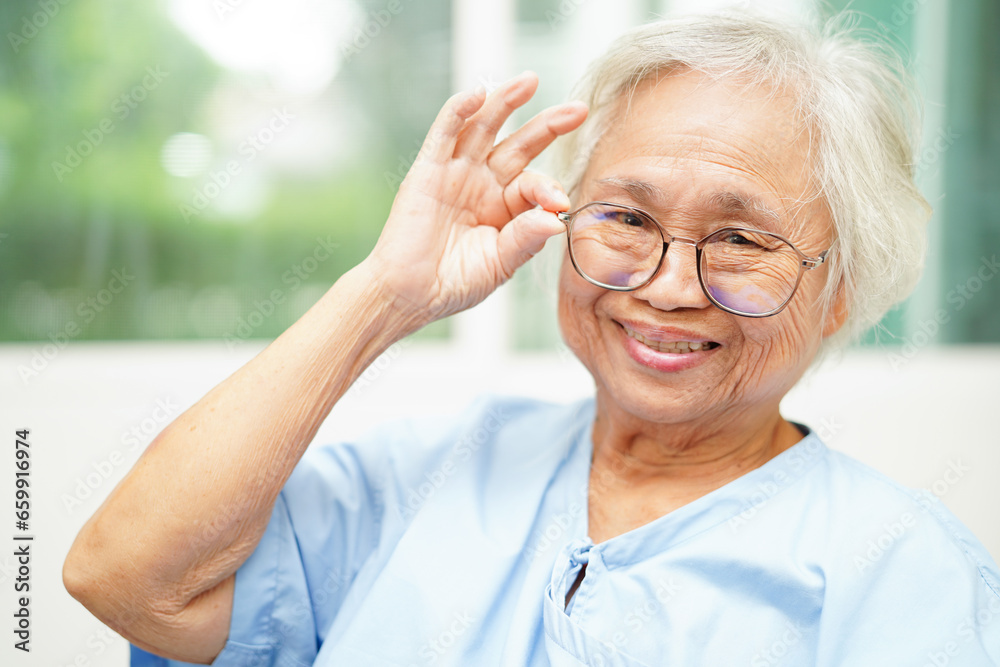 Asian senior woman wearing eyeglasses or vision glasses at home care service. Asian senior woman wearing eyeglasses or vision glasses at home care service.