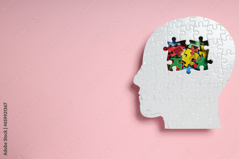 Puzzle head on pink background, space for text Puzzle head on pink background, space for text