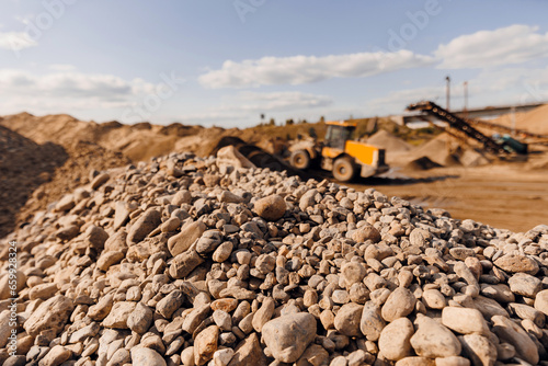 Closeup gravel and sand blur background Excavator work on industrial quarry