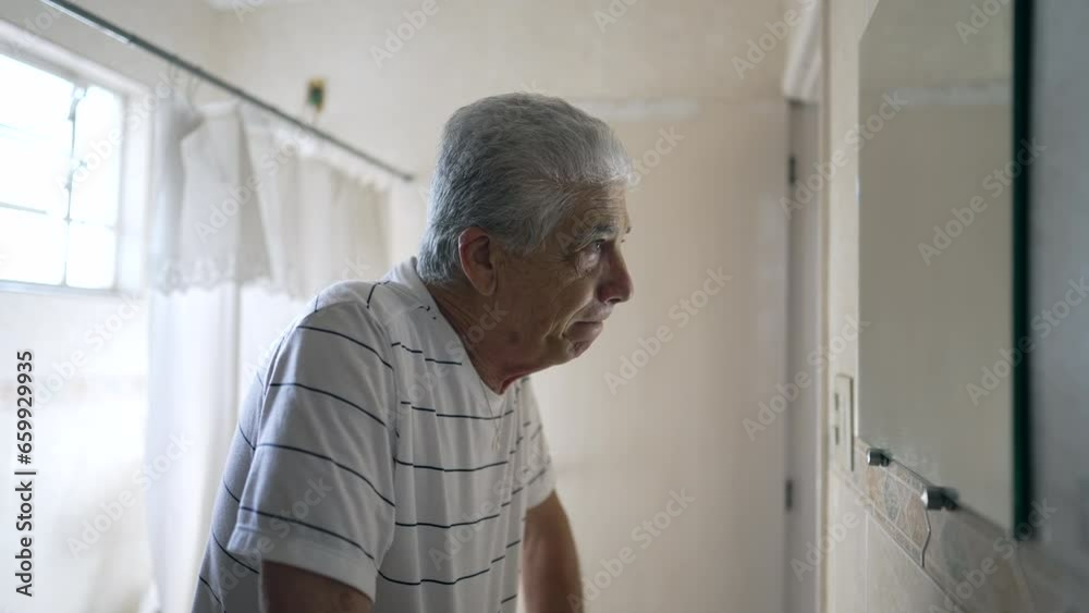 Caucasian Senior Man Reflecting on Regret and Sorrow, Contemplating Old Age in Bathroom Mirror Caucasian Senior Man Reflecting on Regret and Sorrow, Contemplating Old Age in Bathroom Mirror