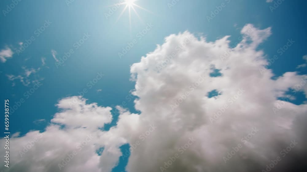 white cumulus clouds move across the blue summer sky sunny weather.