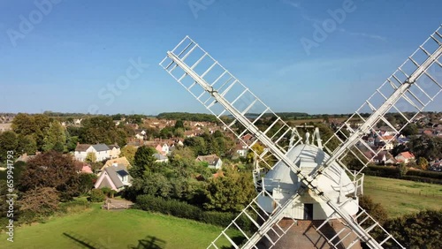 Flying right past Thaxted windmill. Thaxted is a popular tourism in Essex, UK, famous for its traditional architecture and cultural festivals. photo