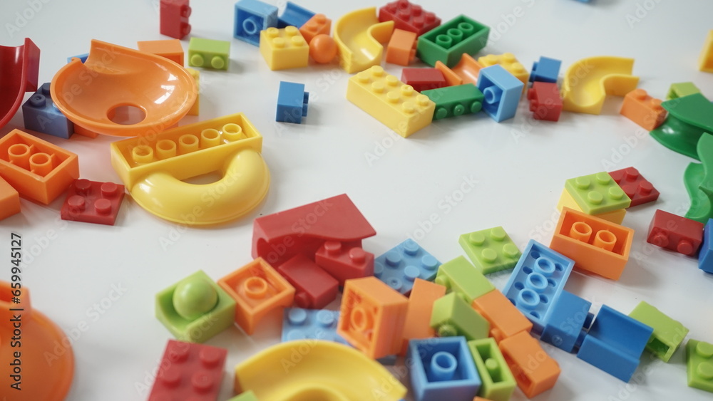 Plastic building blocks on a white background, close-up. Plastic building blocks on a white background, close-up.