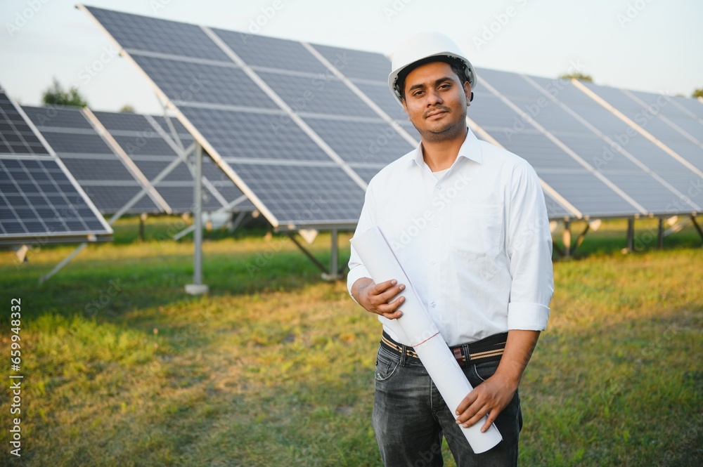 Portrait young indian technician or manager wearing formal cloths standing with solar panel. renewable energy, man standing crossed arm, copy space