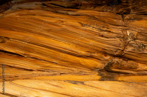 Full frame of sandstone rock pattern, Rock formation, natural of sand stone on beach in Australia, line and curve of stone use for background