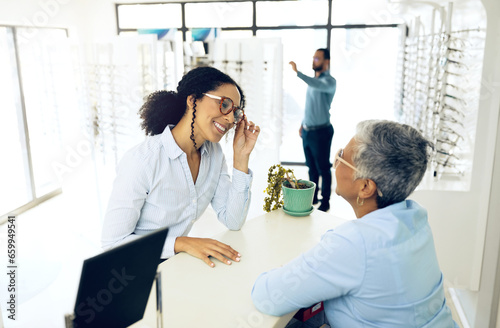 Optometry, consulting or happy woman with glasses for vision in a retail optical or eyewear store. Shopping, talking or biracial customer with new spectacles or senior optometrist at optics clinic