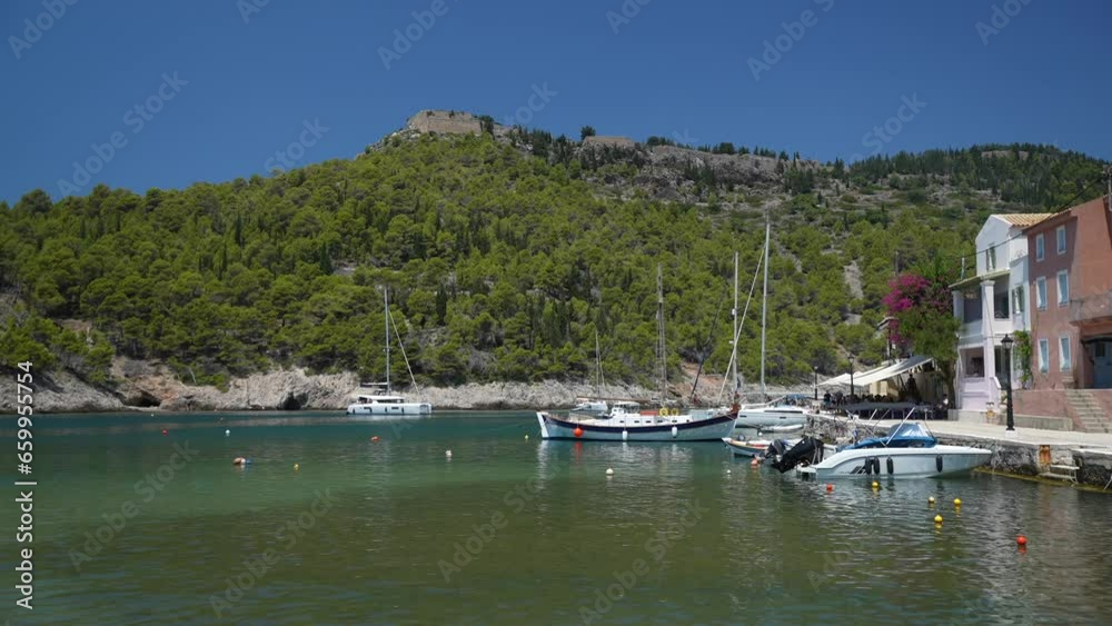 View of hilltop castle, harbour and colourful houses in Assos, Assos, Kefalonia (Cephalonia), Ionian Islands, Greek Islands View of hilltop castle, harbour and colourful houses in Assos, Assos, Kefalonia (Cephalonia), Ionian Islands, Greek Islands