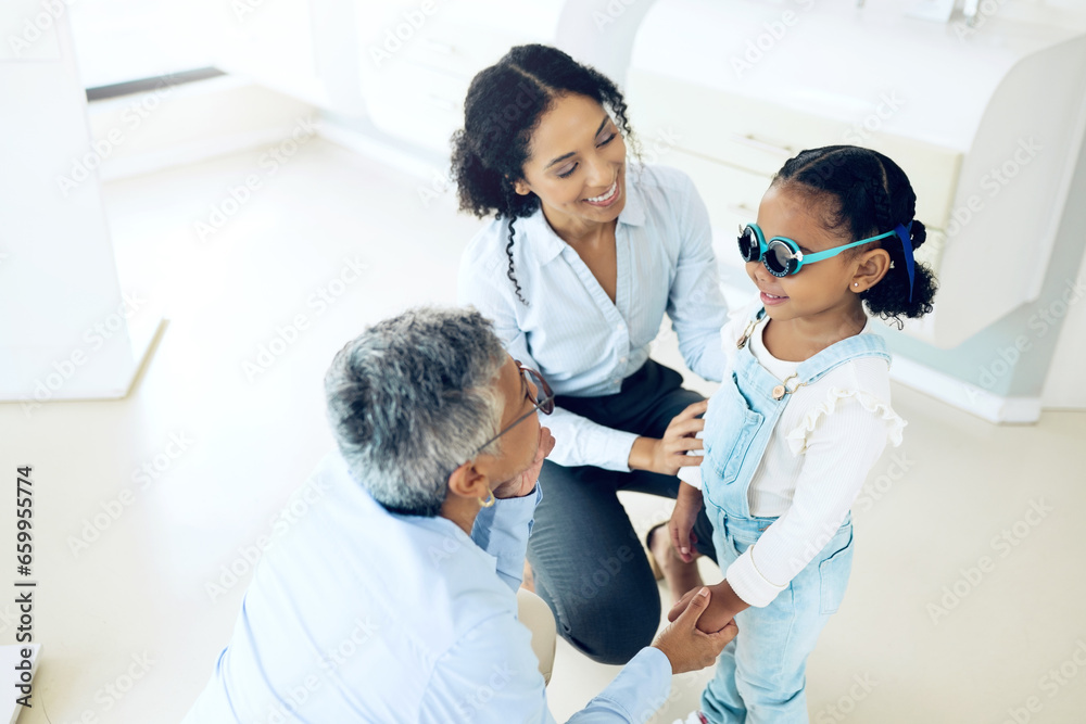 Optometry, glasses and optometrist with child and mother at an eye care appointment for test. Health, wellness and senior optician with young mom and girl kid patient with lenses in an optical clinic Optometry, glasses and optometrist with child and mother at an eye care appointment for test. Health, wellness and senior optician with young mom and girl kid patient with lenses in an optical clinic
