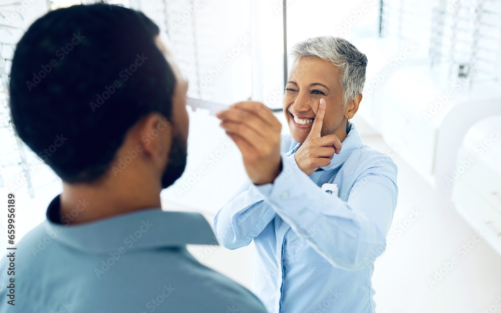 Obraz premium Woman, optometrist and patient for eye test, measurement and optical health and wellness. Happy mature doctor, smile and care for vision at clinic, ruler and fitting or exam for lenses and frame