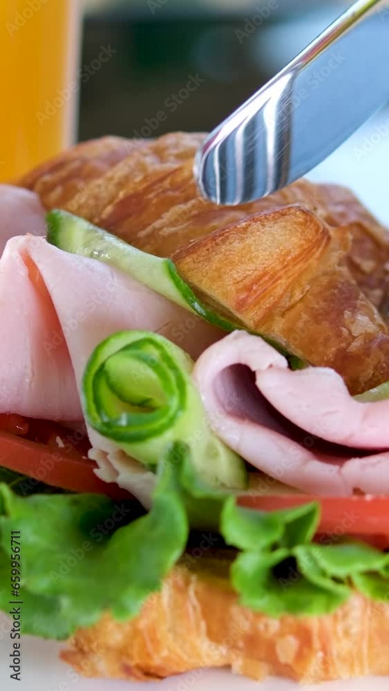 croissant with balyk and cucumber Lettuce leaves tomato delicious breakfast with cheese and orange juice on white plate bacon layers in sandwich on the balcony. delicious food lunch snack croissant with balyk and cucumber Lettuce leaves tomato delicious breakfast with cheese and orange juice on white plate bacon layers in sandwich on the balcony. delicious food lunch snack