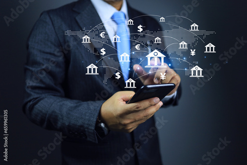 Businessman using global mobile banking application and international currency transaction by smartphone such as US dollars, Yen, EURO. Currency exchange money transfer concept.