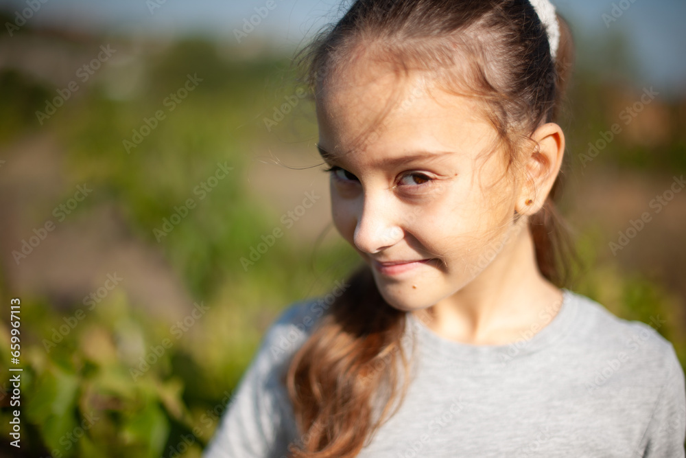 portrait of a  caucasian girl in nature. long hair wearing a gray T-shirt