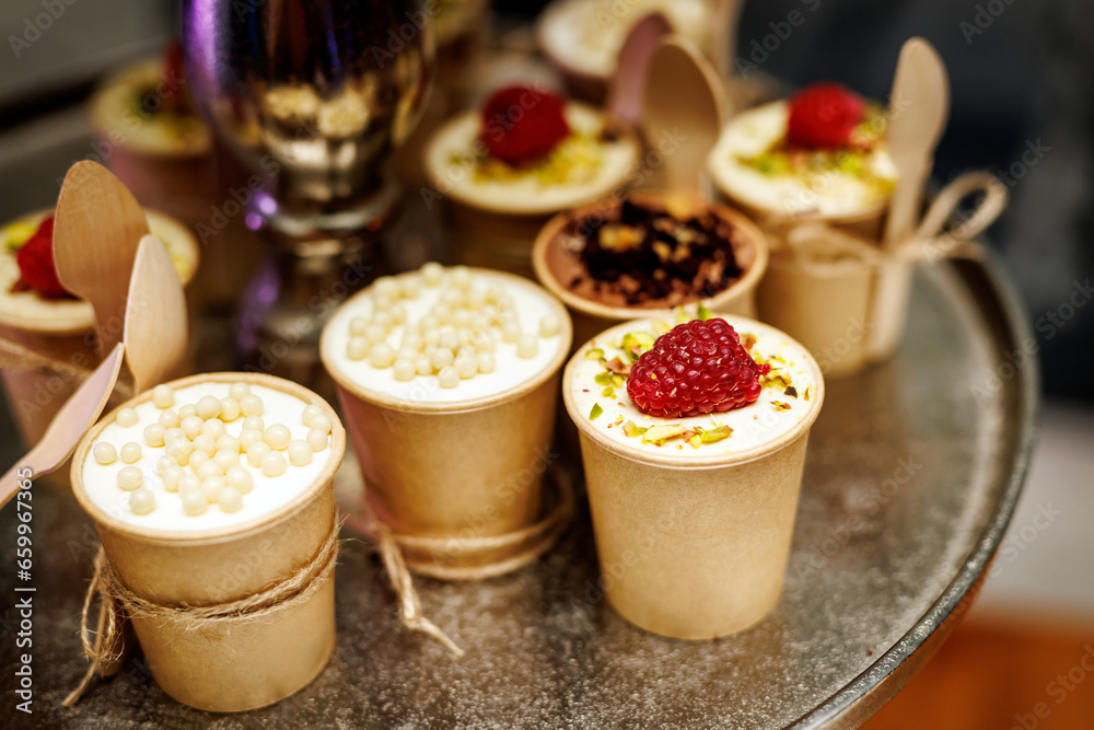 Mug cakes with raspberry in paper cups. Mug cakes with raspberry in paper cups.