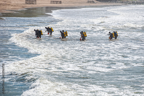 Photos Ten tactical divers, frogmen, enter the sea from the beach