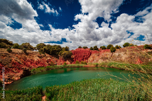The spectacular colors of the Bauxite Quarry in the surroundings of Otranto, Lecce province in Puglia, Italy.  photo