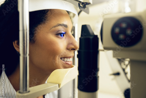 Woman, eye exam and optometry for vision, medical and healthcare consultation or glaucoma check. Happy client with laser technology, blue light or machine for scanning eyes and ophthalmology test