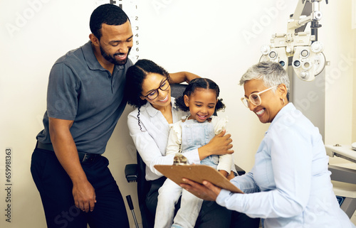 Family, optometry and eye care with a woman doctor in a clinic to see a patient for vision assessment. Mother, father and daughter at the optometrist for an appointment to test eyesight for kids