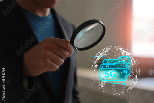 Business man use magnifying glass look 5G Global