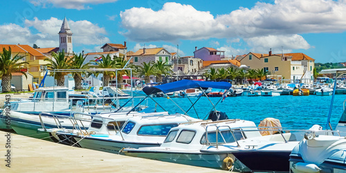 Beautiful mediterranean yacht harbor with old medieval village background against blue summer sky - Pakostane, Croatia