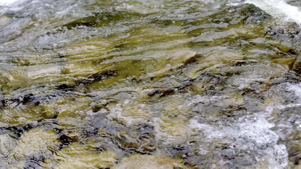 Transparent water in river moving. Rock wild, aqua purity splash motion, freshness close-up, view bottom, peaceful underwater Transparent water in river moving. Rock wild, aqua purity splash motion, freshness close-up, view bottom, peaceful underwater