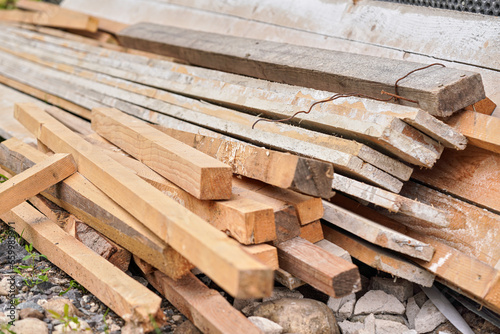 Many wooden boards and beams at construction site, closeup detail © Lubo Ivanko