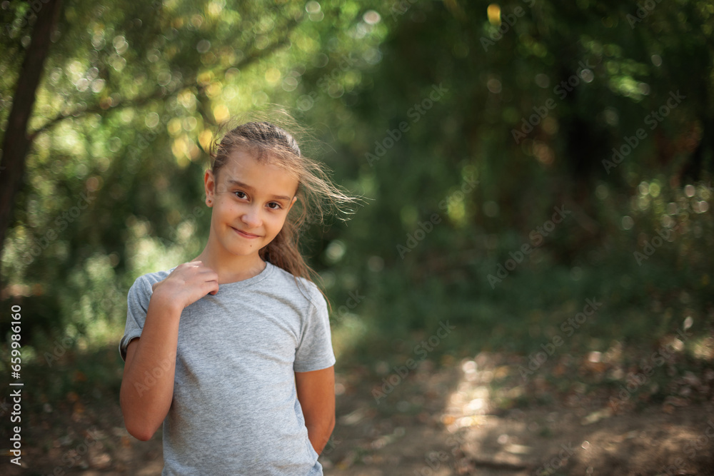 portrait of a cute caucasian girl in the forest on a warm autumn day. hair fluttering in the wind portrait of a cute caucasian girl in the forest on a warm autumn day. hair fluttering in the wind