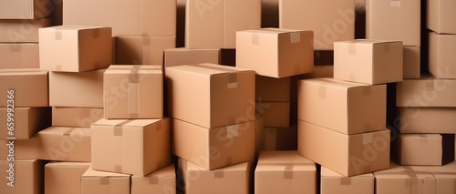 Huge pile of many cardboard plain boxes on a light background. Creative wallpaper concept of moving  housewarming  delivery company  transportation. Kraft boxes.