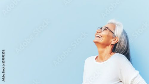 PortBeautiful elderly senior woman with grey hair wearing in glasses and sportswear smiling. Mature old lady close up portrait. Concept of health, menopause and self care. Copy space