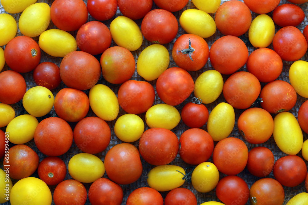 Texture of red and yellow cherry tomatoes Texture of red and yellow cherry tomatoes
