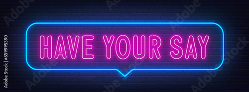 Have Your Say neon sign in the speech bubble on brick wall background.