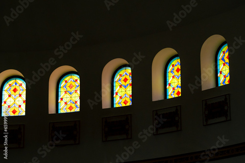 Large stained glass window with frescoes and Arabic hieroglyph in the hall inside the mosque © Guys Who Shoot