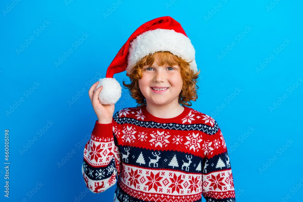Photo of positive cute little boy dressed ugly pullover x-mas hat smiling isolated blue color background Photo of positive cute little boy dressed ugly pullover x-mas hat smiling isolated blue color background